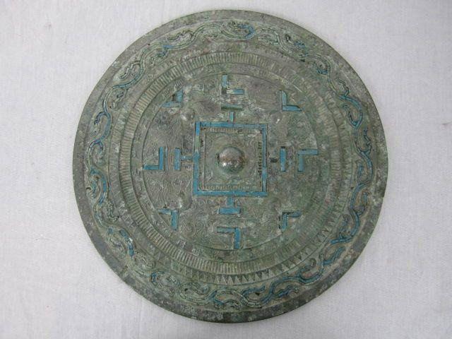 A41-40 CHINESE SILVERED BRONZE MIRROR: With turquoise. Probably Han Dynasty. In good condition. Measures 12 1/2" diameter.