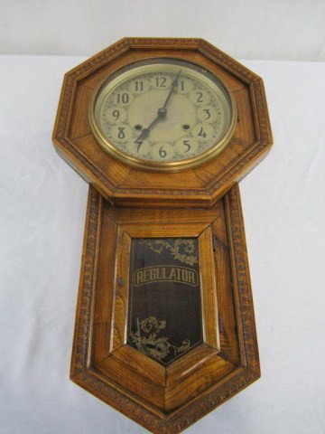 C51-1 REGULATOR WALL CLOCK: In good condition. Measures 22 1/2" tall x 12" wide. Estimate $50 - $100