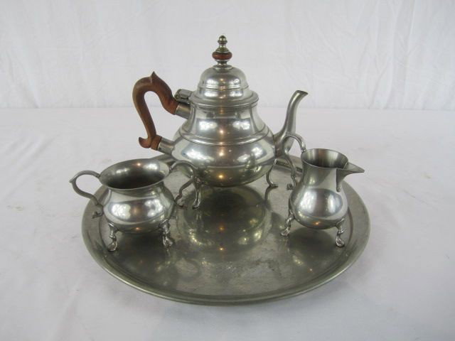C80-9 PEWTER TEA SET WITH TRAY: Fair condition with showing some wear. Tea pot measures 9" tall and tray 14" in diameter. Estimate $25 - $75