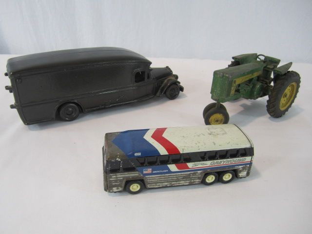C93-49 VINTAGE TOY TRUCK, BUS & JOHN DEERE TRACTOR: All in good condition with minor wear from age. Largest measures 4" tall x 13 1/2" long. Estimate $50 - $100