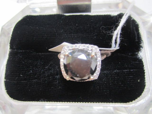 A34-27 14KT WHITE GOLD BLACK & WHITE DIAMOND RING: One prong set round brilliant cut diamond, measuring 10.70 - 10.50 x 8.30mm, Clarity Declasse, Color Fancy black. Forty five prong set single cut diamonds, measuring 1.10 - 1.00 x 0.63mm, Clarity VS-1