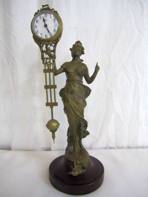 C78-8 SMALL SWINGER CLOCK: Circa 1900. Measures 11" tall. Estimate $100 - $300
