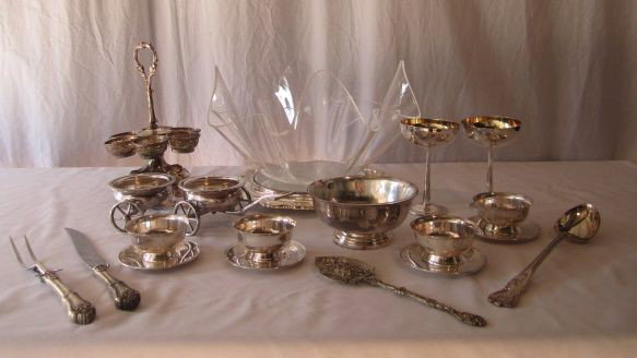 D31-24 LOT OF 19 ASSORTED SILVER PLATE ITEMS: Includes bowl with glass insert, 4 small bowls with saucers, 4 utensils, 2 wine glasses, platter with plastic bowl, serving wagon and tall serving piece. Largest 11 1/2" tall. Estimate $100 - $300