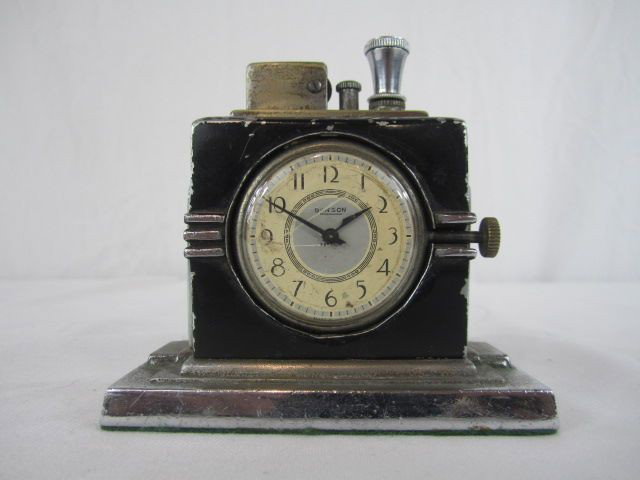 A44-157 RONSON CIGAR LIGHTER CLOCK: Measures 4 1/2" tall. Estimate $200 - $300