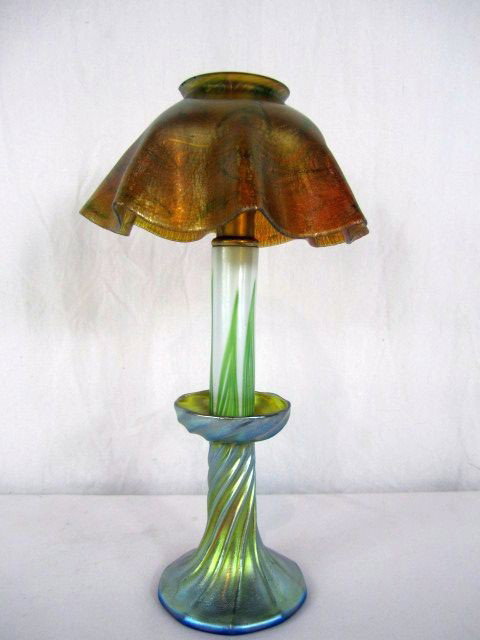 A44-9 TIFFANY STUDIOS CANDLE LAMP: Signed. Shade has minor chip on rim. Measures 12 1/2" tall. Estimate $1,200 - $1,500