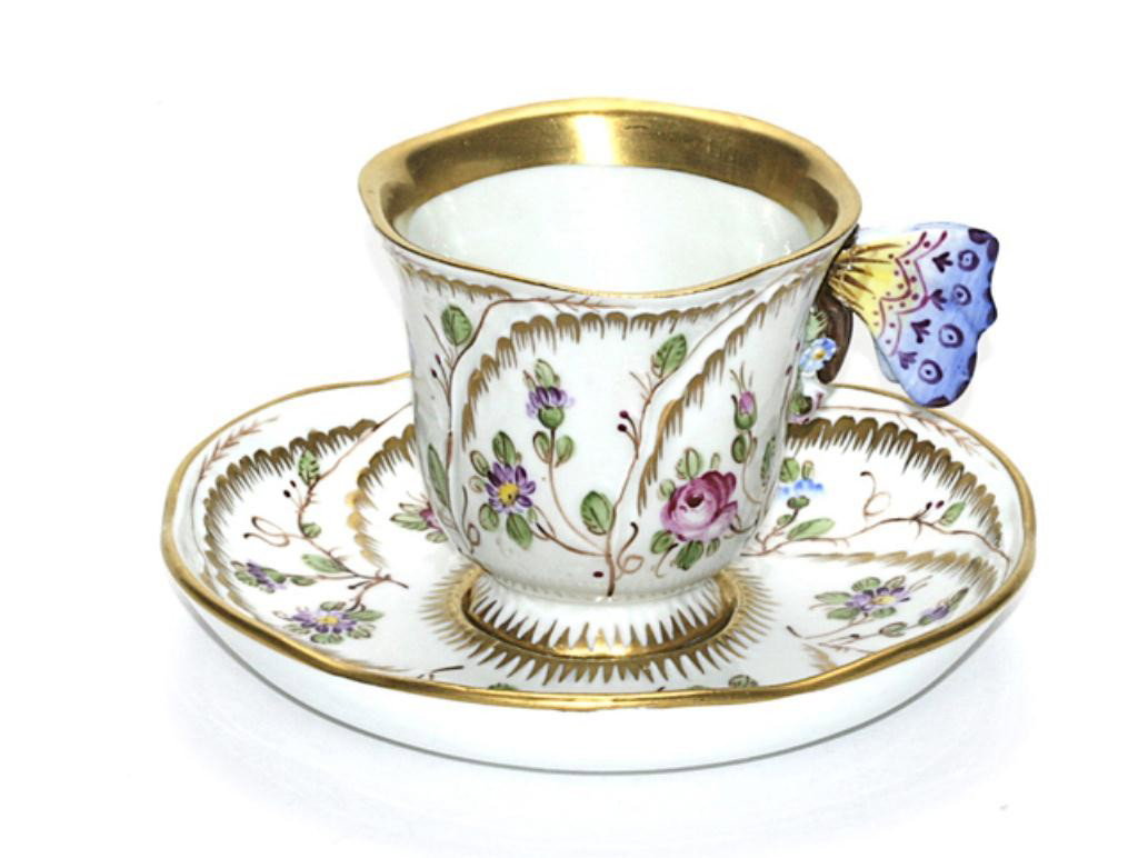 F60-181 SEVRES CUP & SAUCER: With butterflies. Cup measures 2 1/2" tall and saucer 5 1/2" diameter. Estimate $500 - $900