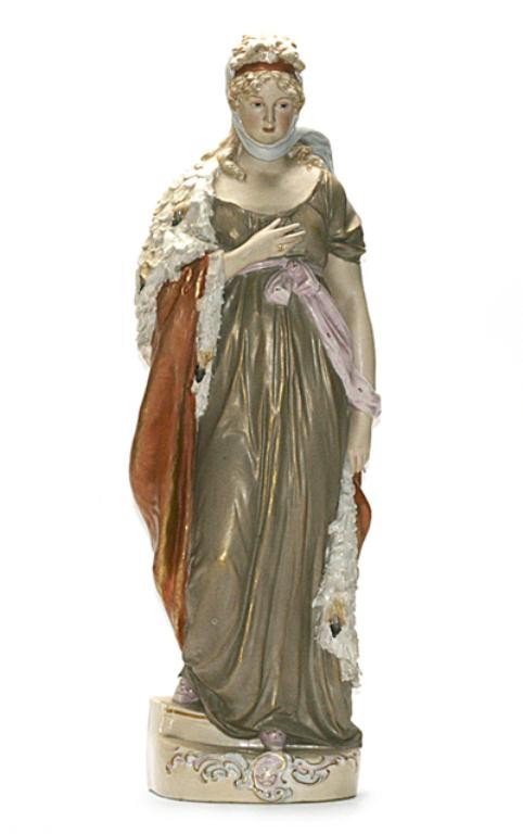 F60-144 ROYAL DUX PORTRAIT FIGURINE: Royal princess wearing a classical style gold dress and feathered robe with pink raised Royal Dux mark on base and numbered "248". Measures 17 1/2" tall. Estimate $200 - $500