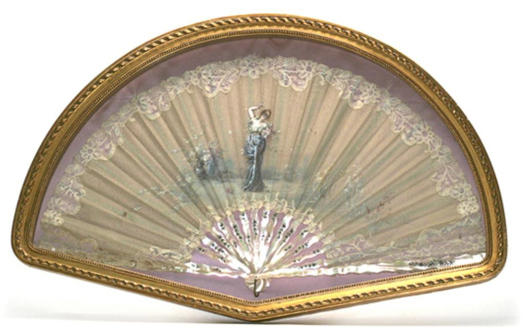 F60-218 FAN IN A BOX: 19th Century. Circa 1900. Hand painted with lovely maiden holding flowers and decorated mother-of-pearl handle. Encased in modern frame Measures 18" tall x 28" wide. Estimate $400 - $800