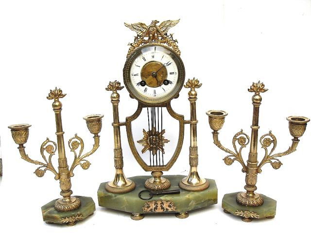 F60-109 GILT METAL & MARBLE CANDELABRA CLOCK SET: The 8 day two train movement, signed A. D. Mougin stamp. Having anchor escapement striking the hour and half hour on a bell. The case cast with drumhead clock and love birds on top, dial signed Paris,