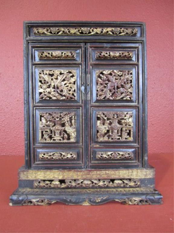 F29-20 TABLETOP WOODEN CHEST: With gold accent paint. Damaged due to age. Measures 17 1/2" tall x 11 1/2" wide x 5" deep. Estimate $50 - $100