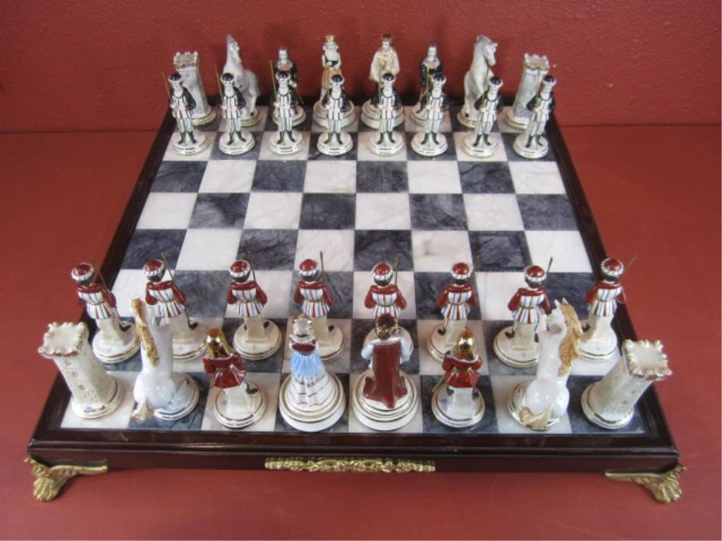 F92-3 CAPODIMONTE CHESS SET: With marble base. Circa 1890. Includes plexi-glass cover (purchased later). Chess board measures 27 1/2" x 27 1/2". Chess pieces measure average 6" tall. Estimate $1,200 - $1,800