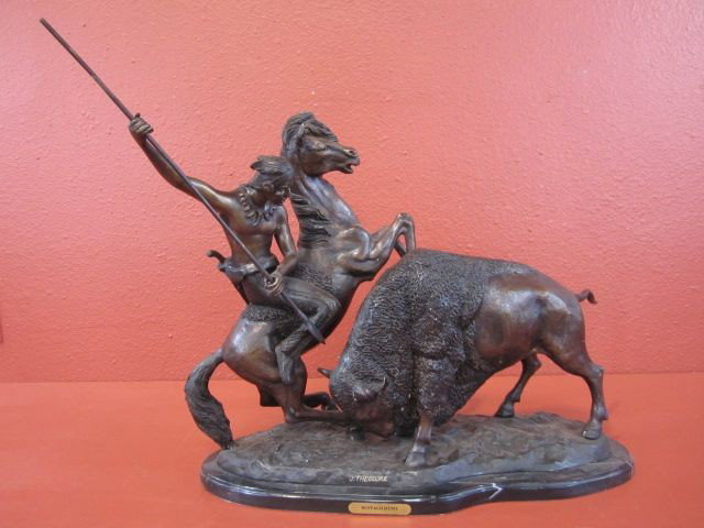 G21-1 "BUFFALO HUNT" BRONZE ON MARBLE BASE: Signed J. Theodore. Measures 23 1/4" tall x 24 1/2" wide x 10" deep. Estimate $400 - $500