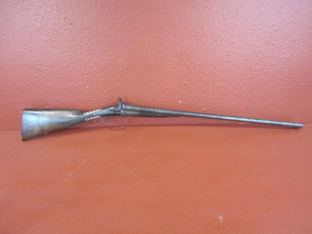 A20-5 ENGLISH TWIN BORE 12 GAUGE SHOTGUN: Circa 1880. Great old stock repair. Mills - wall hanger. Measures 46 1/4" long. Estimate $200 - $500