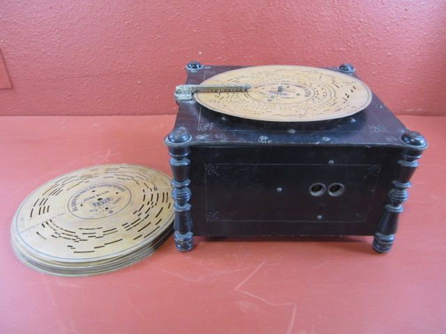 G47-4 ARISTON DISC PLAYER: With 14 records. The bellows are bad. Measures 9 1/4" x 15 3/4" x 15 3/4". Estimate $300 - $500
