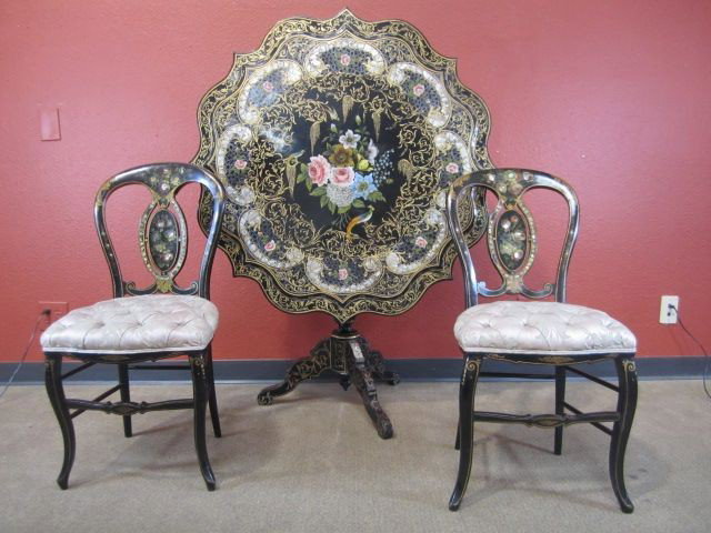 A11-35 PAPER MACHE TABLE WITH 2 CHAIRS: Tilt top table with two matching chairs with fabric seats. All hand painted with inlaid mother of pearl. Signed "Jose Rivera". Table measures 30 1/2" tall x 41 1/4" diameter. Estimate $4,500 - $6,000