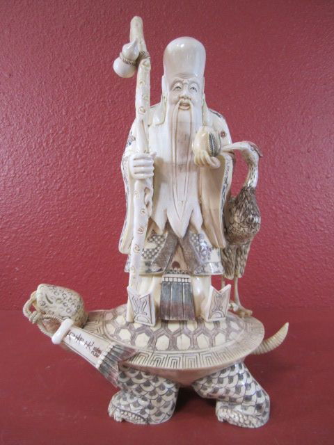 A10-6 BONE OLD MAN & BIRD ON TURTLE: Measures 17" tall.