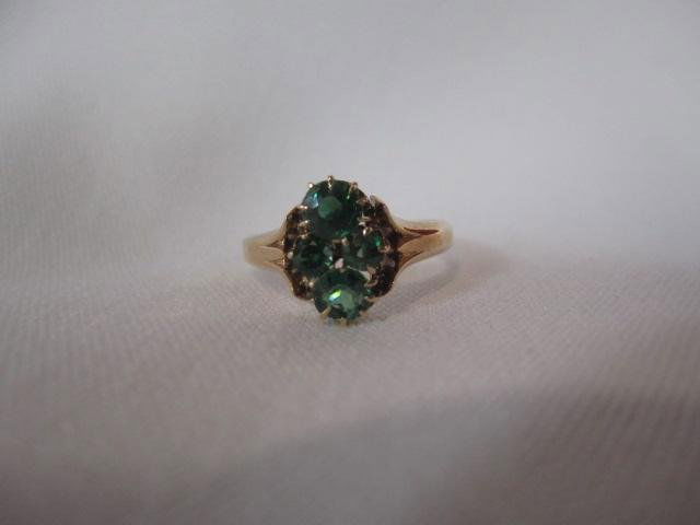 A27-35 ENGLISH ANTIQUE RING SET IN EMERALDS: 0.33% rose gold set with 4 round emeralds. Estimate $240 - $400