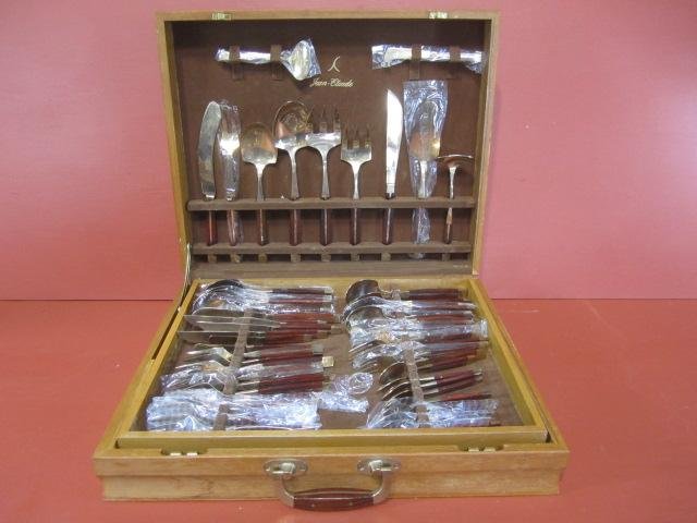 E51-5 JEAN-CLAUDE NICKEL BRONZE FLATWARE SET: With brass inlaid rose wood handles. Total of 91 pieces. Comes with original lined box. Estimate $200 - $500