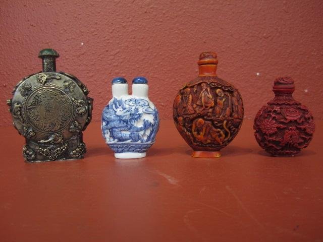 E12-6 LOT OF FOUR SNUFF BOTTLES: 1 double lidded blue/white snuff bottle with Dragons. Signed on bottom. 2 carved cinnabar snuff bottle and signed at bottom. 1 mixed metal snuff bottle with jewels and signed at bottom. Largest measur
