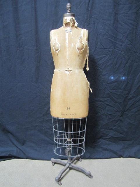 E77-2 JR BAUMAN NEW YORK VINTAGE DRESS FORM: Model 1942 size 14. Cast iron base with casters. Measures 61" tall. Estimate $200 - $400 Starting Bid $50