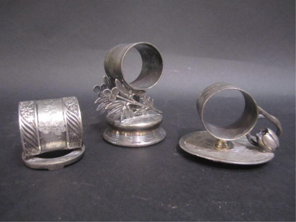 E33-64 THREE VICTORIAN NAPKIN RING HOLDERS: One Signed Pairpoint, One Marked Miller & Co. Estimate $200 - $300. Starting Bid $100.