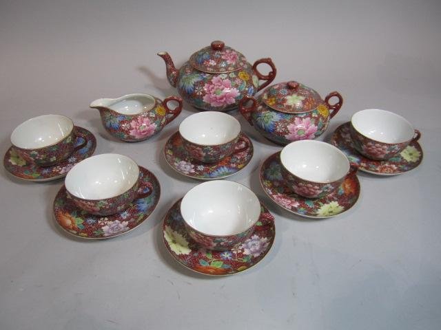 E14-4 ROSE MEDALLION FAMILLE PORCLAIN TEA SET: Including covered tea pot, covered sugar & creamer with 6 cups and saucers. Largest measuring 5 3/4" Tall. Estimate $100. - $300. Starting Bid $100.