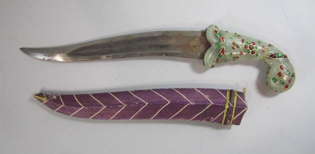 A45-58 MUGHAL JADE & JEWELED DAGGER: With six large diamonds, many large rubies and emeralds. Consignor believes dagger and jade handle is from the 19th century. The jewels possibly could have been added at a later date. They are real je