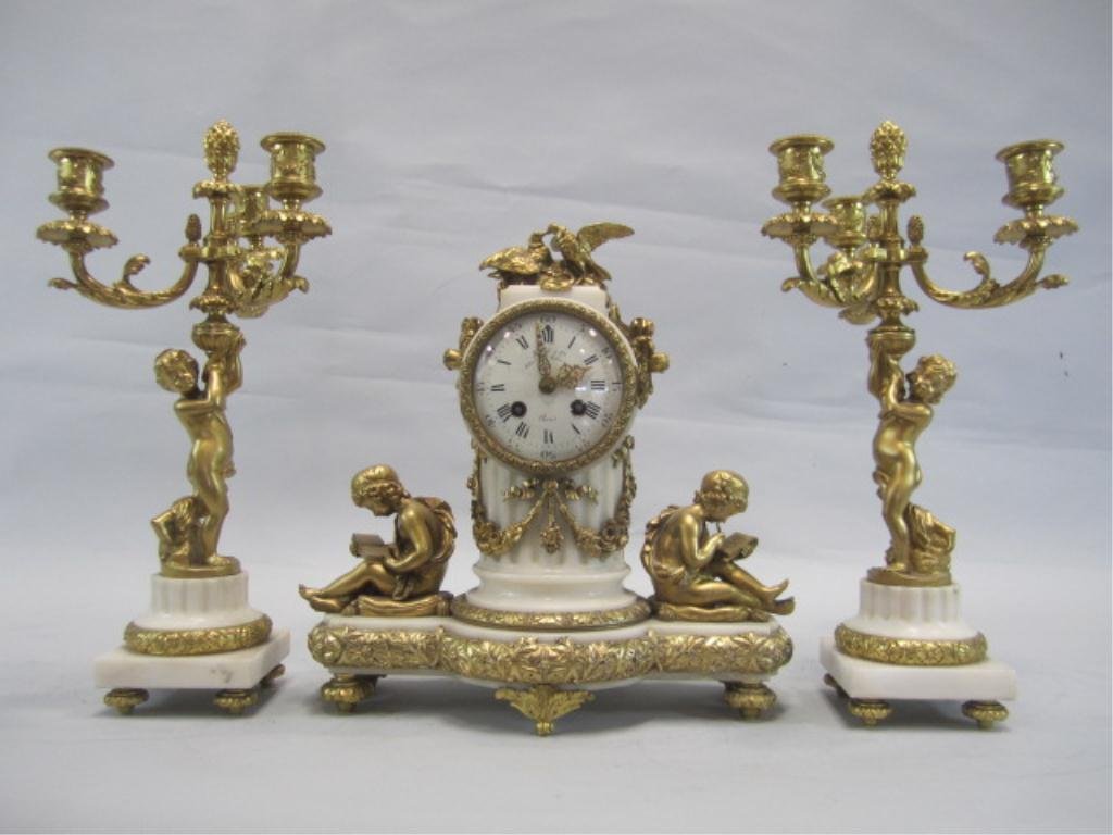 NY133 BRONZE & MARBLE 3PC CLOCK SET: 19th century. Clock measure 13" tall and matching garnitures 16" tall. Estimate $2,000 - $4,500 Starting Bid $1,000
