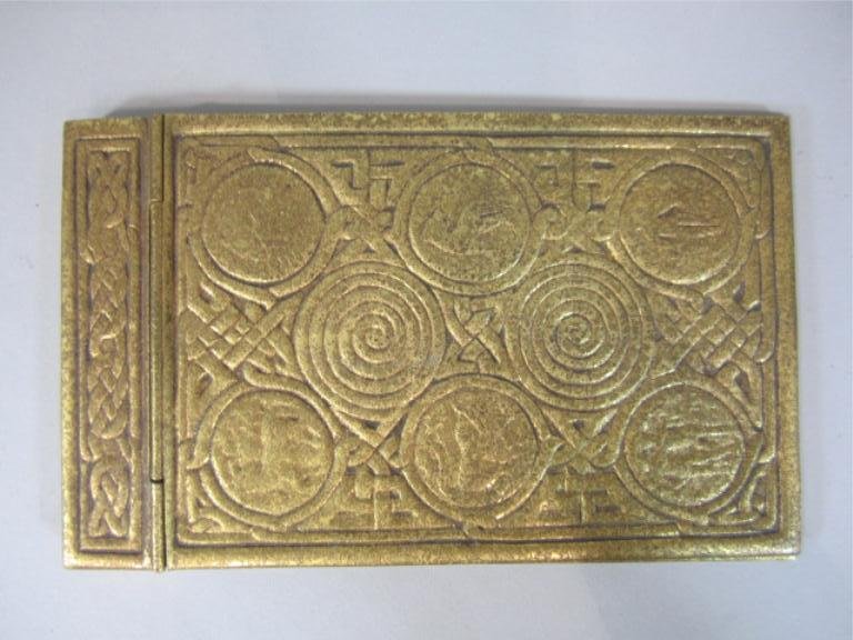 A44-25 TIFFANY STUDIOS ZODIAK PAD HOLDER: Signed. Measures 7 1/2" x 4 1/2". Estimate $400 - $600 Starting Bid $100