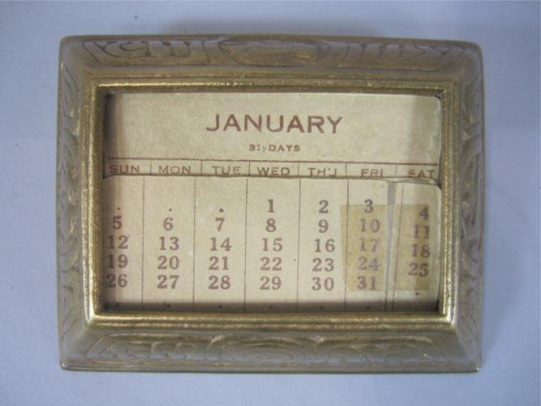 A44-26 TIFFANY STUDIOS ZODIAK CALLENDAR: Signed. Measures 1 3/4" x 4 1/2" x 3 1/2". Estimate $400 - $600 Starting Bid $100