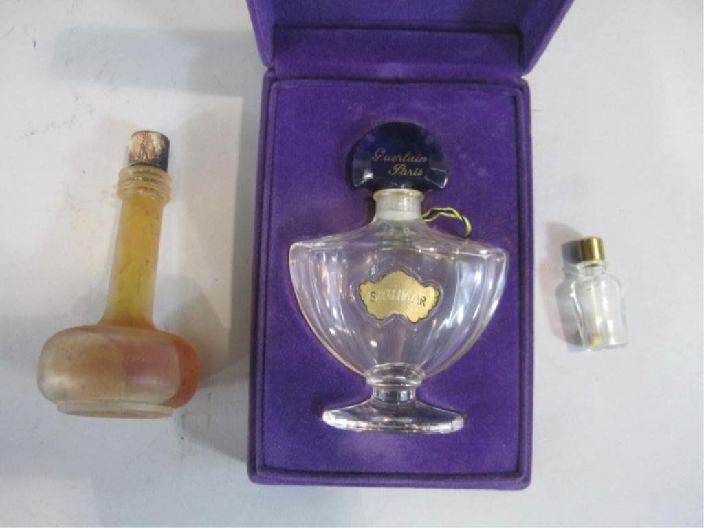 H49-1 LOT OF 3 VINTAGE PERFUMES: One Baccarat "Guerlain Shalimar" perfume and two miscellaneous perfumes. Measures 4", 4" and 3/4" tall. Estimate $300 - $600 Starting Bid $50