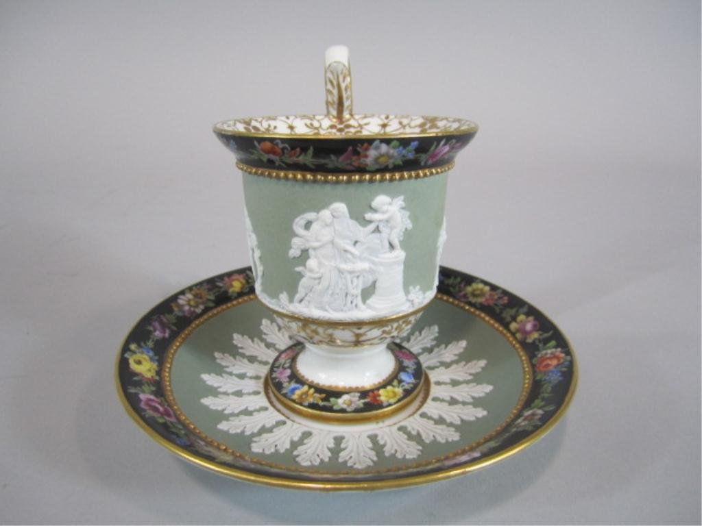 H63-7 MEISSEN PORCELAIN CUP & SAUCER: Hairline age crack and saucer has been repaired. Cup measures 4 1/2" tall and saucer 5 1/2" diameter. Estimate $200 - $400 Starting Bid $100
