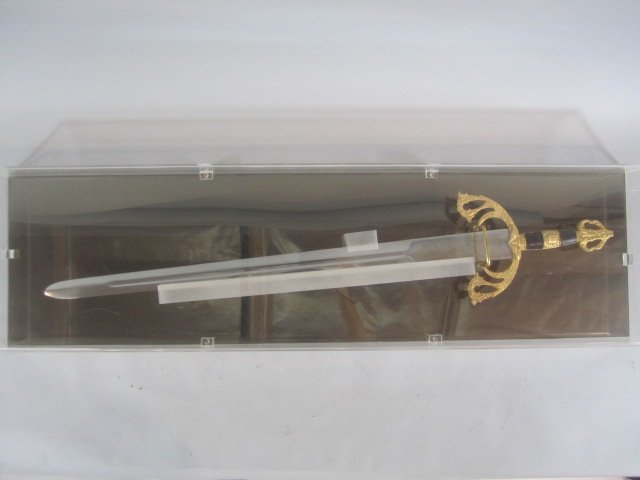 H61-7 KERSHAW SWORD: In plexiglass case. Plexiglass in fair condition. Sword measures 39" long. Estimate $200 - $400 Starting Bid $50