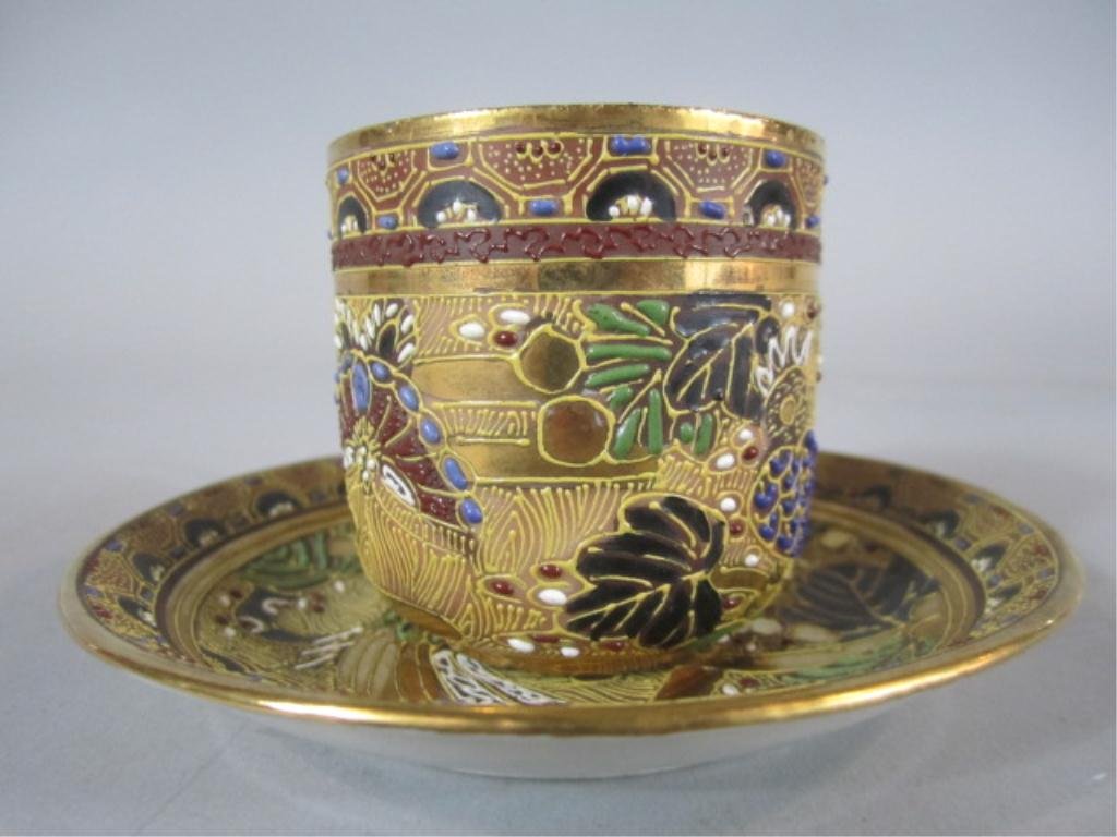 H70-19 ROYAL SATSUMA CUP & SAUCER: Bird of Paradise design. Circa 1870. Cup measures 2 1/8" tall and saucer 4 1/2" diameter. Estimate $100 - $200 Starting Bid $50