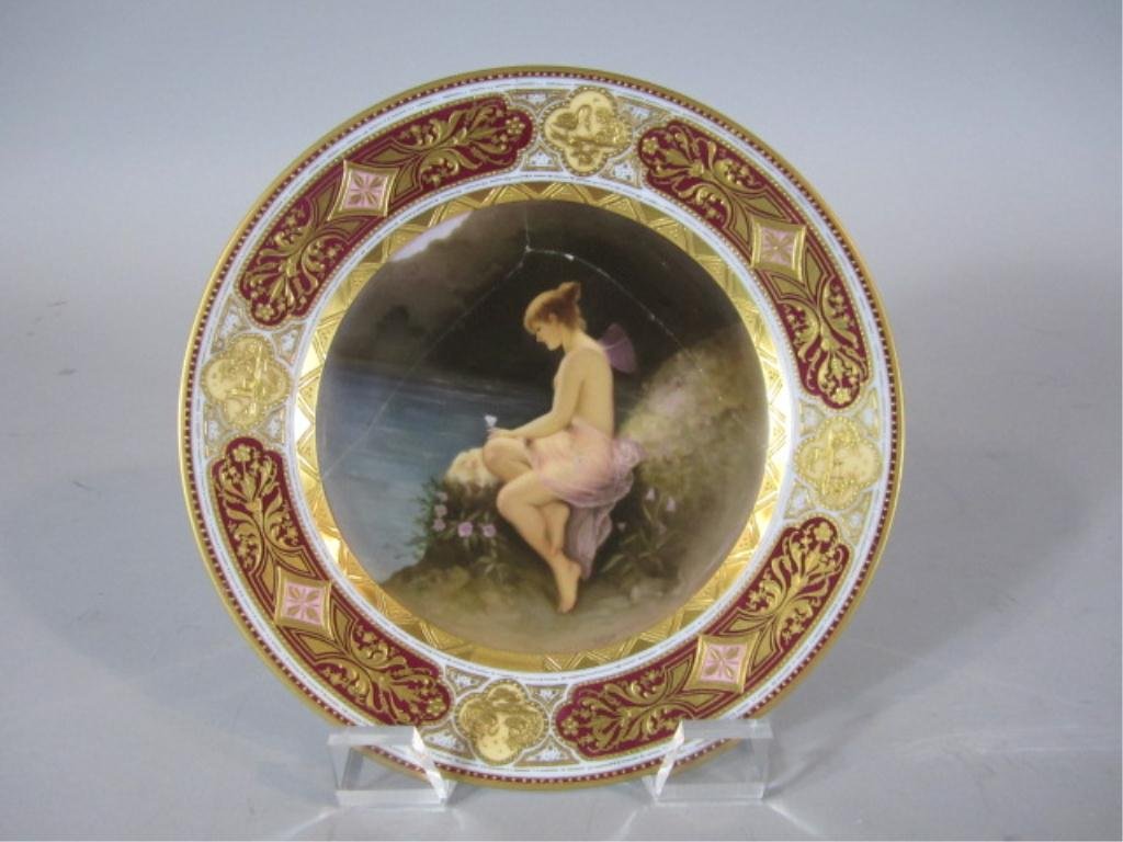 H70-25 ROYAL VIENNA PLATE: Artist signed. This beautiful plate has been broken and stapled. Stapling was a rare repair tactic used mostly in 18th century. Some people used to buy only pieces fixed in this manner. Measures 9 1/2
