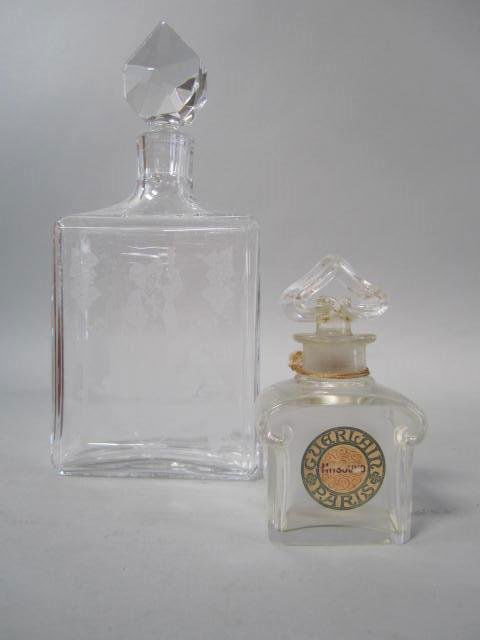 D51-45 TWO BACCARAT DECANTERS: Early to mid 20th century. One label reads "Guerlain Paris" 4 1/2" tall with small chips on stopper bottom and one with etched scene 10 1/2" tall in good condition. Estimate $100 - $200 Starting Bid $
