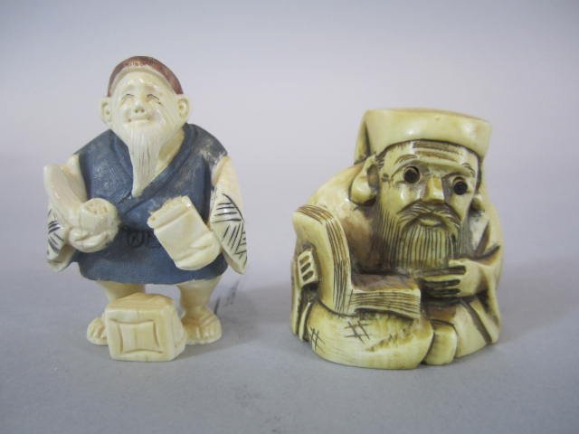 H30-41 TWO CARVED IVORY NETSUKES: With signatures. Eyes pop out on one. Measures 2" tall. Good condition. Estimate $300 - $400 Starting Bid $30