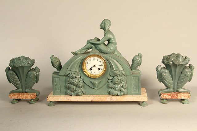 C45-25 SPELTER ART DECO 3PC CLOCK SET: Clock measures 15" tall x 20 1/2" wide and matching garnitures measure 8 1/2" tall. Good condition. Estimate $300 - $500 Starting Bid $100