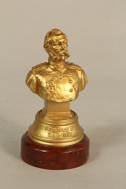 C45-61 GILT METAL RUSSIAN ALEXANDER II: Dated 1818-1881. Name is in Russian mounted on rouge marble. Measures 5 1/2" tall. Good condition. Estimate $300 - $400 Starting Bid $100