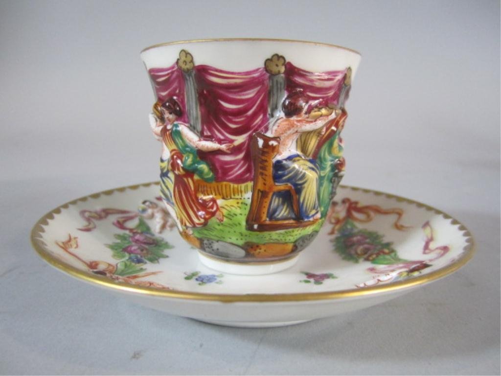 H70-7 ROYAL NAPLES CUP & SAUCER: With dancing scene. Cup measures 2 1/4" tall and saucer 4 5/8" diameter. Good condition. Estimate $100 - $200 Starting Bid $50