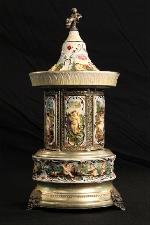 C78-51 Porcelain Lip Stick Music Box: Holds 6 lipsticks. Circa 1950's 15" tall. Good condition. Estimate $400 - $600. Starting Bid $50.