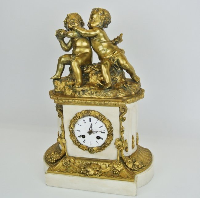 19TH CENTURY GILT BRONZE AND MARBLE CLOCK: A 19th century ormolu mounted marble clock, measures 17" h. Estimate $1.000-1.500