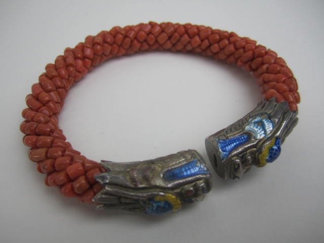 CORAL BEADED BANGLE: With silver and enamel. Estimate $400 - $500. Starting bid $200