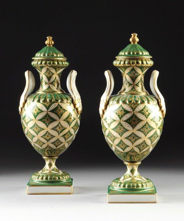 PAIR OF FRENCH GILT PORCELAIN COVERED URNS: OVERGLAZE BLUE CROSSED ARROWS MARK, LATE 19TH/EARLY 20TH CENTURY, each of ovoid form with sides of stylized "X" form trellis enclosing floral sprays beneath a reeded molded collar continuing to a circ