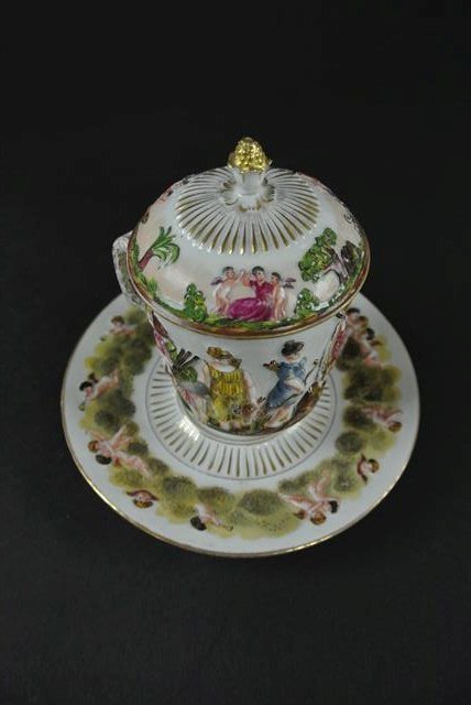 19 CENTURY CAPODIMONTE CHOCOLATE CUP & SAUCER: Cup measures 5" tall. Saucer measures 5 7/8" diameter. Estimate $300 - $400. Starting bid $250