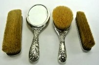 FOUR PIECE 800 SILVER VANITY SET: Mirror measures 10 1/4" long. Estimate $200- 300. Starting Bid $100.
