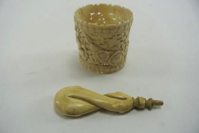 CARVED DIEPPE IVORY NAPKIN RING AND SEAL HANDLE: The napkin ring from Dieppe, France and carved with cherubs and flowers. The ivory seal handle with braided pattern. Estimate $150- 200. Starting Bid $10.