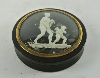 LARGE TORTOISE SHELL SNUFF BOX WITH IVORY CAMEO: With carved ivory Silhouette under convex glass. Measures 3 1/2" diameter. Estimate $500- 700. Starting Bid $350.