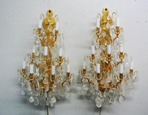 PAIR OF GOLD DORE OVER BRONZE WALL SCONCES: 9 light. Red rock crystal pendants all hand made, plus various hi line crystal fillers. Sconces have dimmer control on line design. Estimate $1,000- 1,500. Starting Bid $350.