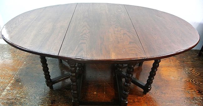 J34-66 SOLID OAK DROP LEAF DINING TABLE: Measures 30" tall x 81" long x 58" wide. Estimate $1,500- 2,000. Starting Bid $10.